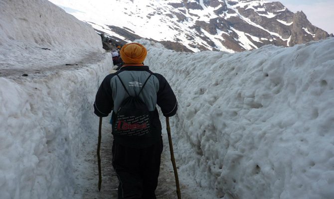 Pilgrims going across the Hemkund Glacier to visit Hemkunt